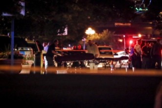 Bodies are removed from the scene of a mass shooting early Sunday in Dayton, Ohio, in which nine people died, the second mass killing in the country in as many days. (John Minchillo/Associated Press)